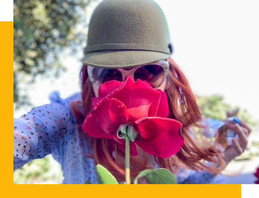 Josephyne sniffs a flower