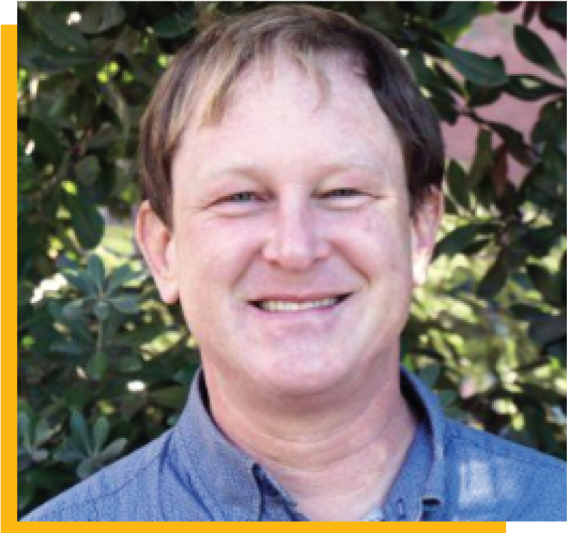 Photo of Paul Franke, outdoor with greenery in the background