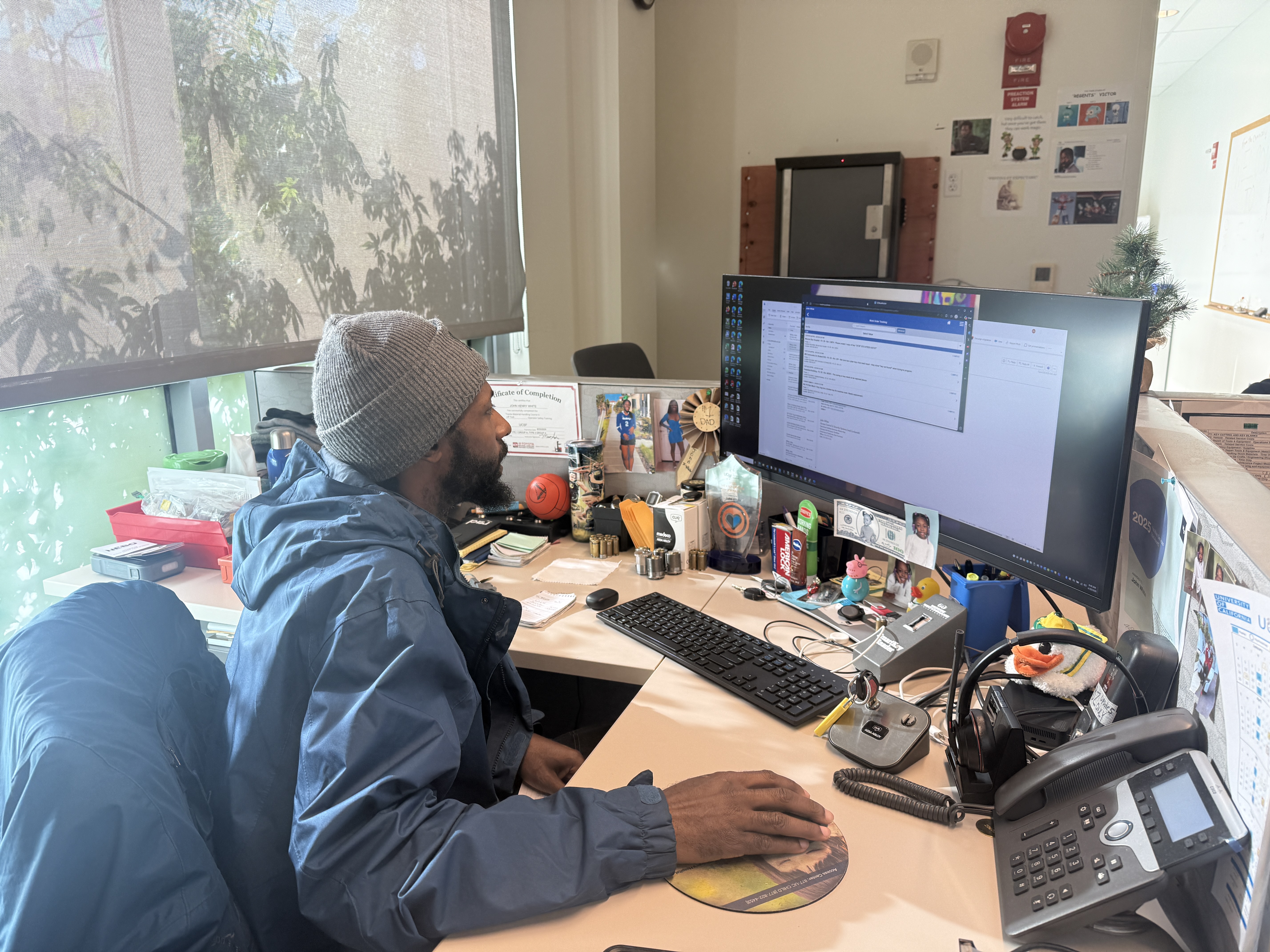 John White working at his desk behind a computer 