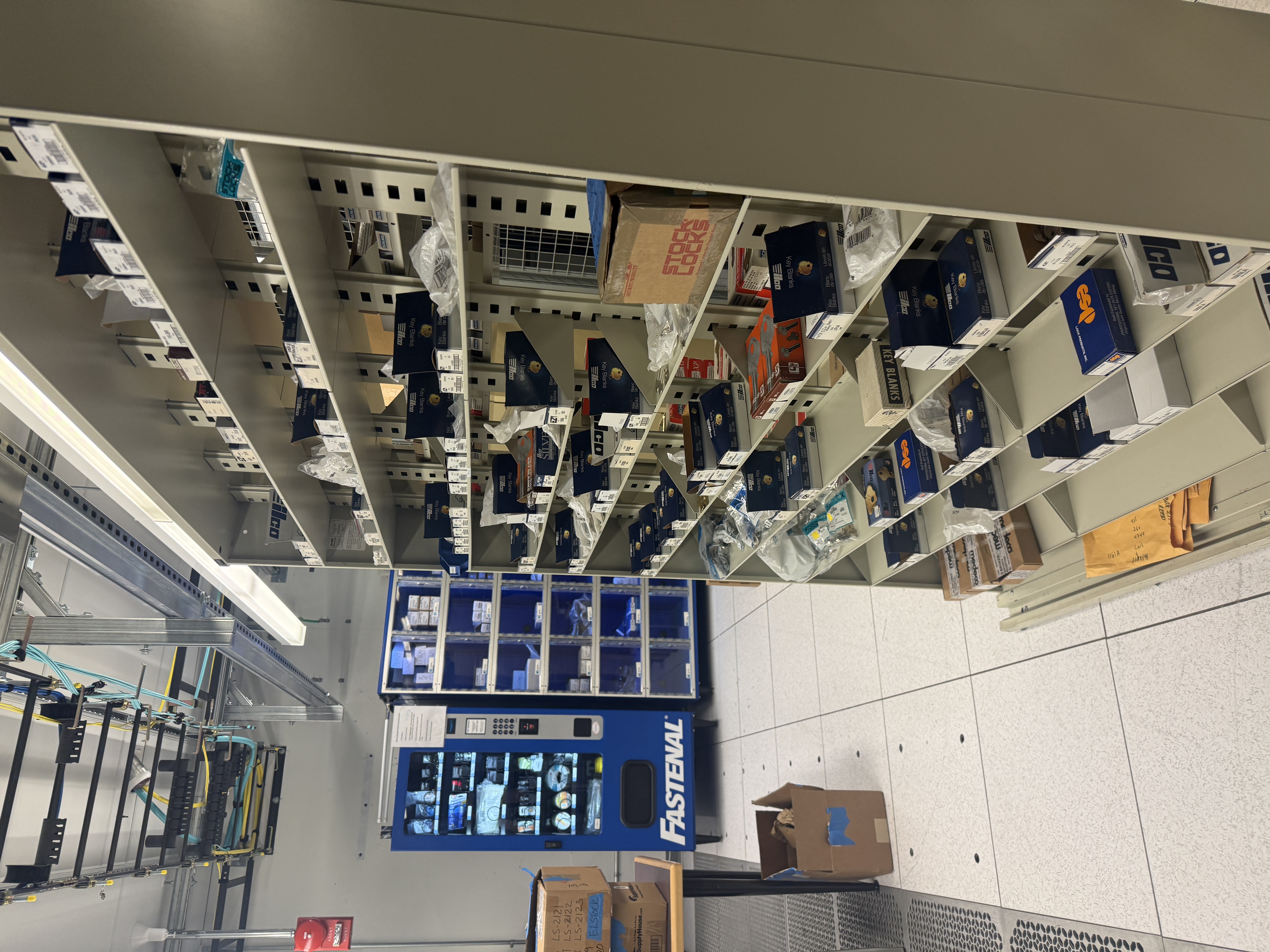 Photo of lock shop, with shelves and tool vending machine 