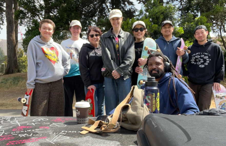 A group of seven Skateboard Club at UCSF members gathering outside  
